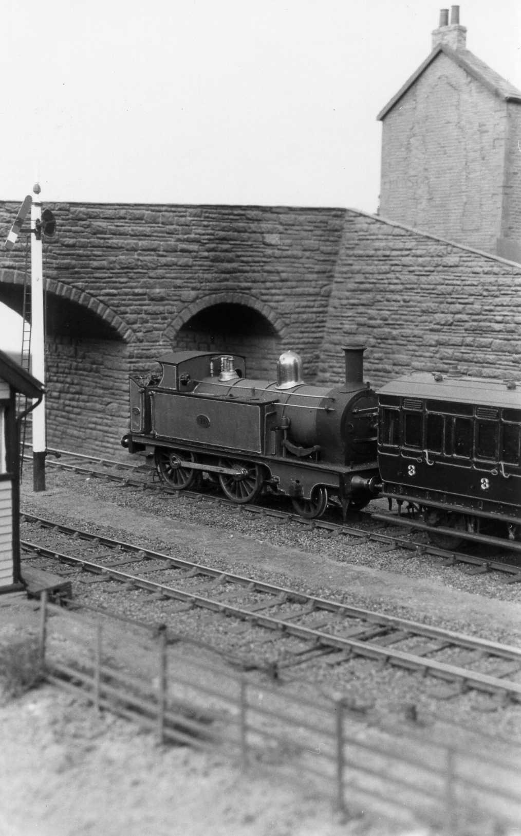 Passenger train departing Llanastr